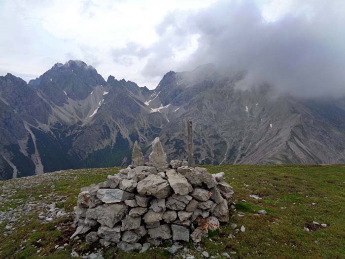 am Gipfel des Sandeck; die Fortsetzung des Grates würde über einen tiefen Sattel erst einfach zum Gamskofel, in weiterer Folge mittels komplizierterer Kletterei zum mächtigen, wolkenverhangenen Kreuzkofel führen