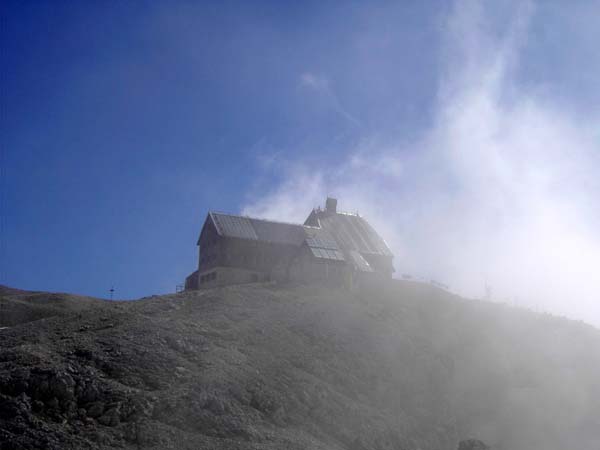 Triglavski dom von SW, hier lockern die dichten Nebel aus der Nordwand langsam auf