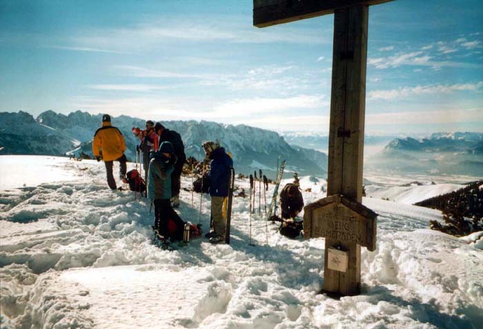 der Breitenstein ist ein Grenzberg zu Österreich; hinter dem Gipfelkreuz das Inntal bei Kufstein